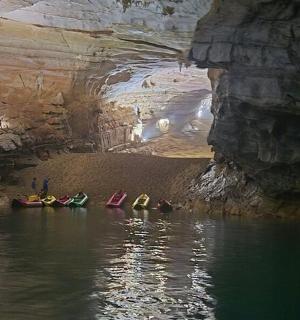 a group of people in the water in a cave