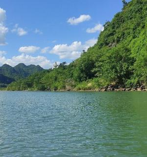 a large body of water in front of a mountain
