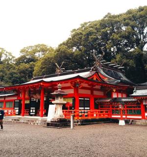 a person walking in front of a red building