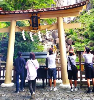 a group of people standing in front of a shrine