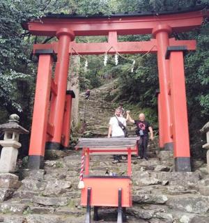 a red arch with a woman and a child standing under it