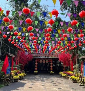 a garden with a bunch of lanterns over a path