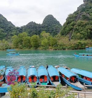 a group of boats on a river with mountains