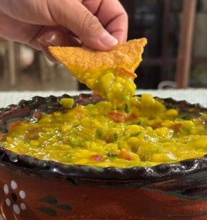 osoba koja drži komad hrane u zdjeli s hranom