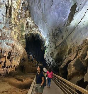 a group of people walking through a cave