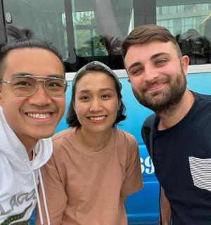 two men and a woman posing for a picture