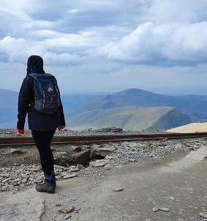 a person standing on the side of a train track
