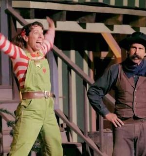 两名男子站在台上,双手高举过头。