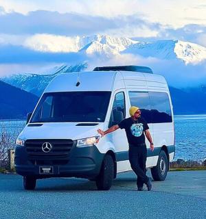 a man is standing next to a white van