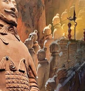 a large statue in a room with a group of statues