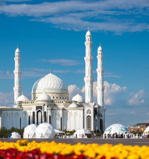 a large white building with white domes and mosques