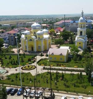 an aerial view of a church in a city