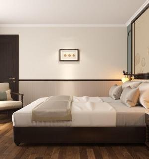 a bedroom with a large bed and a chair