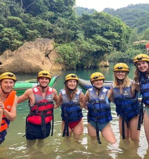 a group of people in the water on a river