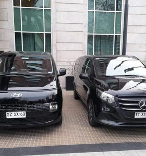 zwei schwarze Autos parkten vor einem Gebäude