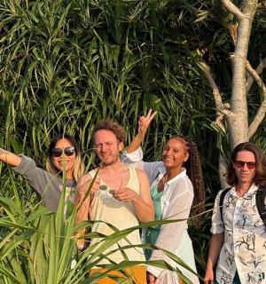 a group of people standing in front of some plants