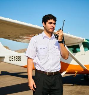 a man is standing in front of a small plane