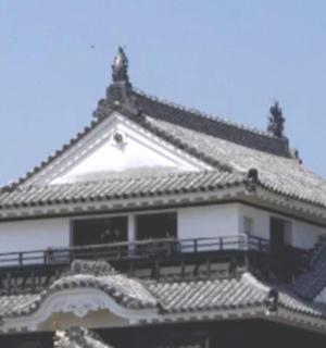 a building with a roof with a sky in the background