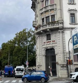 a blue car on a street in front of a building
