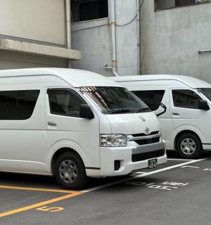 three white vans parked in a parking lot