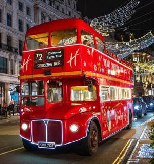 a red double decker bus driving down a street