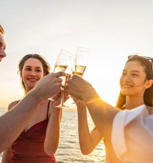 a group of people drinking champagne on a boat
