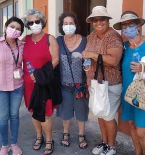 a group of women wearing masks posing for a picture