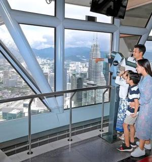 a family standing in an observation tower looking out at the city
