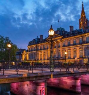a large building with a bridge in front of it