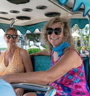 two women and a man riding on a roller coaster