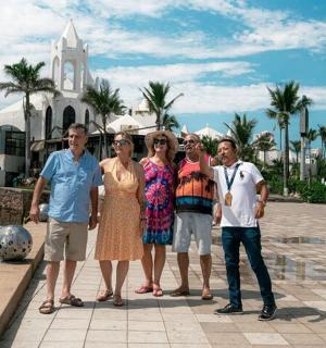 a group of people posing for a picture at a resort