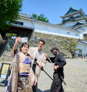 a man taking a picture of a woman in front of a building