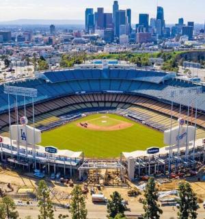 an aerial view of a baseball stadium with a city