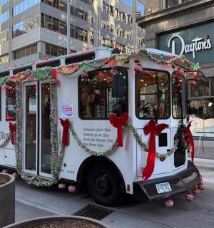a bus covered in christmas decorations on a city street