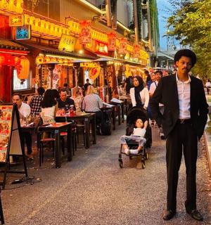 a man in a suit walking down a street
