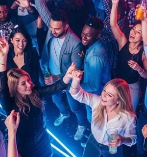 a group of people standing in a crowd at a party