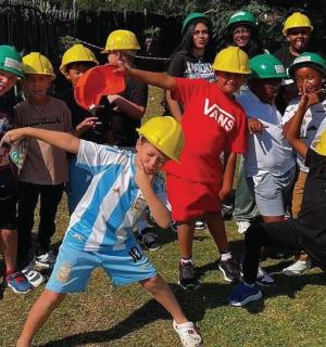 a group of children wearing hard hats posing for a picture