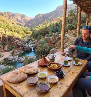 a man and a woman sitting at a table with food