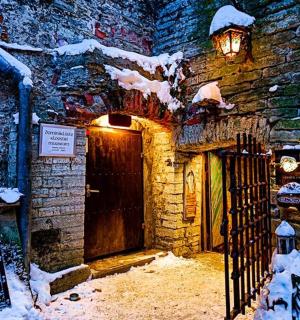 a door to a building with snow on it