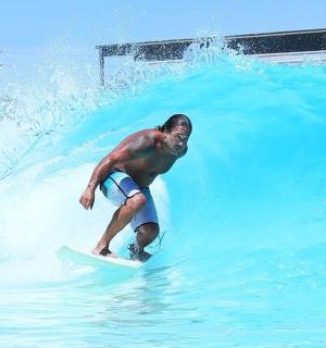 a man riding a wave on a surfboard in the water