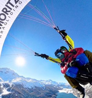a person in the air with a parachute