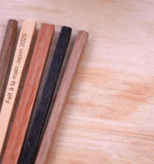 three wooden sticks sitting on top of a table