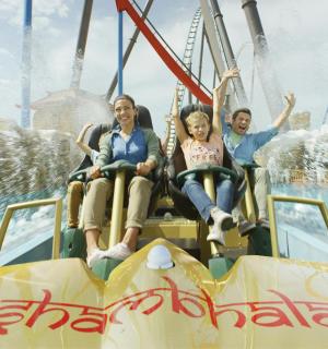 a group of people sitting on a roller coaster