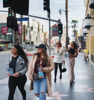 a group of women walking down a city street