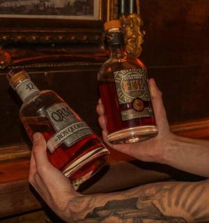 a man is holding a bottle of whiskey