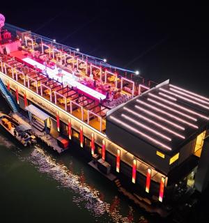 a train sitting on the water at night