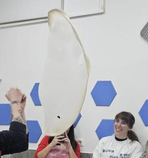 a man holding up a ping pong paddle