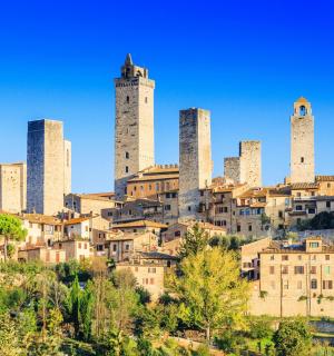a city on top of a hill with tall towers