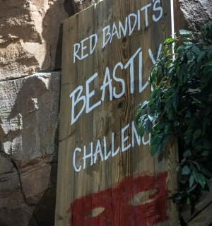 a sign on the side of a stone wall