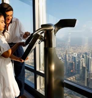 a man and a woman standing on the top of a building